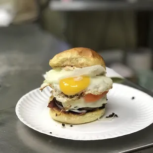 a breakfast sandwich on a paper plate