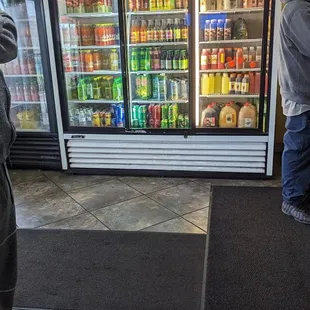 a man standing in front of a refrigerated refrigerator