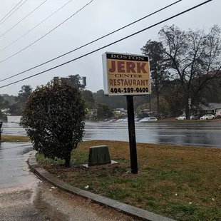 a sign on a rainy day