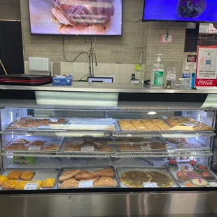 a variety of pastries in a display case