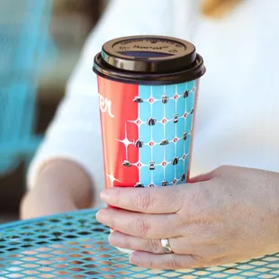 a woman holding a coffee cup