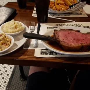 Prime rib, macaroni salad and mashed potatoes.