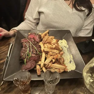 a plate of steak and french fries