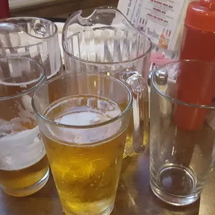 four glasses of beer and a ketchup