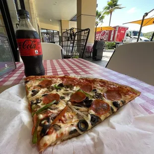 a slice of pepperoni and olive pizza