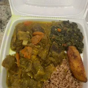 Goat Curry with peas and rice plantain and callaloo