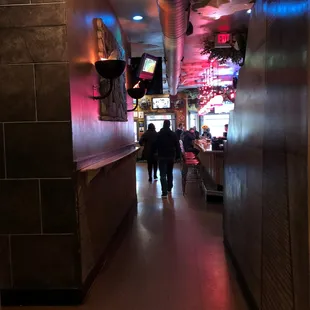 Hallway separating bar space and dining space