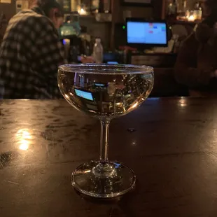 a glass of wine on a bar