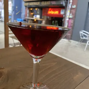a glass of red wine on a table