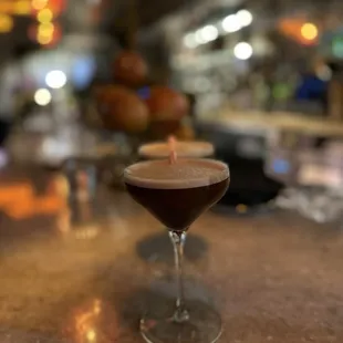 a drink in a glass on a bar