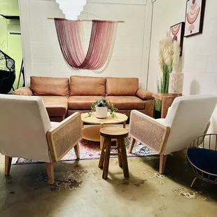 a living room with a couch, chairs, and a coffee table