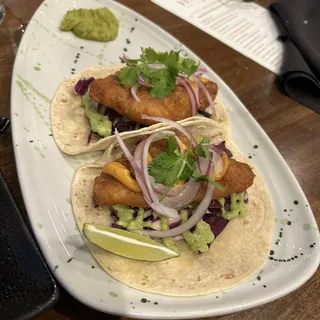 BAJA FISH TACOS Beer battered cod, slaw salad, chipotle mayo, cilantro crema