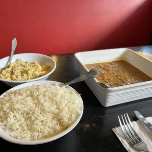 a bowl of rice, a bowl of stew, and a bowl of rice