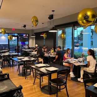 people sitting at tables in a restaurant