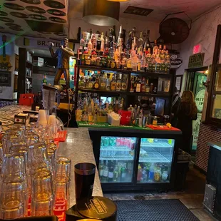 a bar with a lot of bottles on the counter