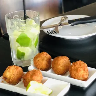 a glass of lemonade and a plate of fried tater tots