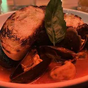 a bowl of seafood and bread