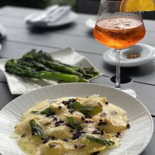 Butternut squash ravioli and grilled broccolini and aperol spritz