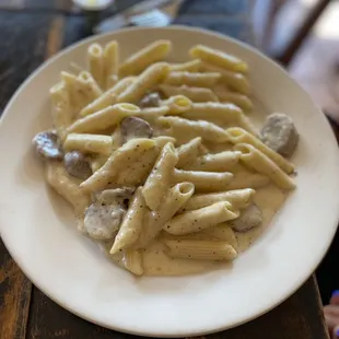 Penne pasta in Alfredo sauce with sausage