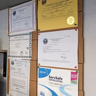 a bunch of papers on a bulletin board