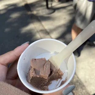a person holding a bowl of ice cream