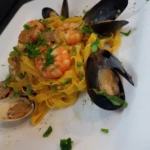 Mussels, clams and shrimp over fresh tagliatelle pasta.