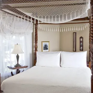The Franz Huning Room on the second floor has a queen canopy bed and clawfoot tub with shower and chandelier in the bathroom.