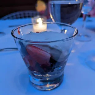 a bowl of fruit and ice cream on a table