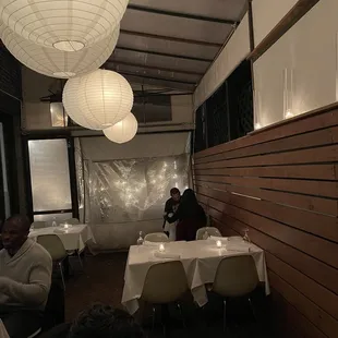 people sitting at tables in a restaurant