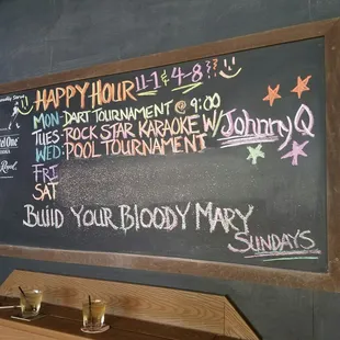 a chalk board with happy hour written on it
