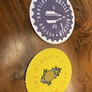 two stickers on a wooden table