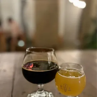 two glasses of beer on a table