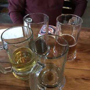 Empty glasses because the brews were tasty.  Bartender was knowledgeable and while staff was very friendly. And we even got a sticker