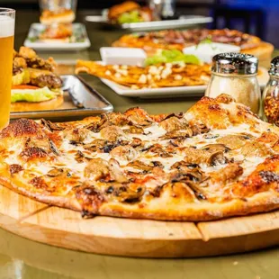 a pizza and beer on a table
