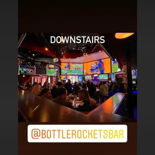 a large group of people sitting at a bar