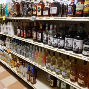 a variety of alcohol bottles on shelves