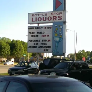 a sign for liquors on the side of the road