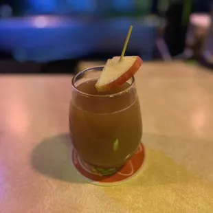 a drink with a slice of apple