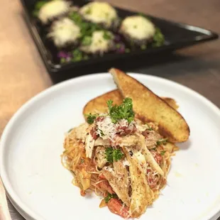 a plate of spaghetti and bread