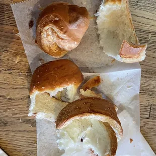 a half eaten sandwich and half eaten pastry