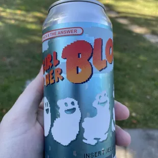 a person holding a can of beer