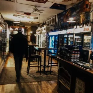 a man walking through a bar