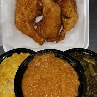 a tray of fried chicken, macaroni and cheese, and a bowl of macaroni and cheese
