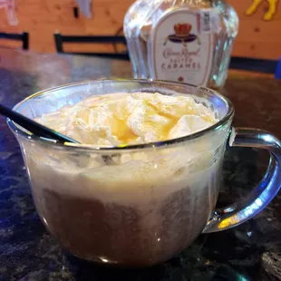 a cup of coffee and a bottle of liquor