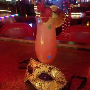 a mask and a drink on a table