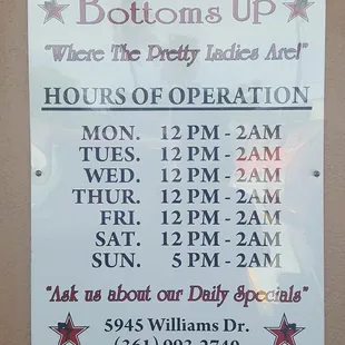 a sign for hours of operation