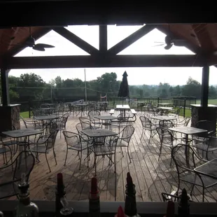 a patio with tables and chairs