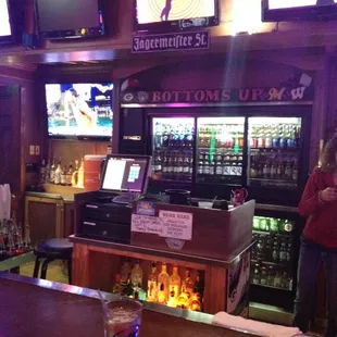 a bar with a man standing at the bar