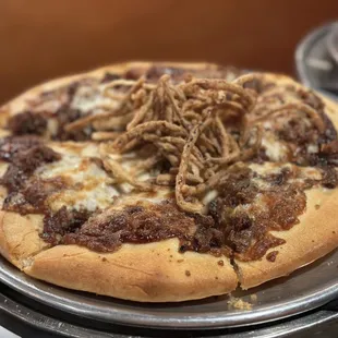 a pizza with meat and cheese