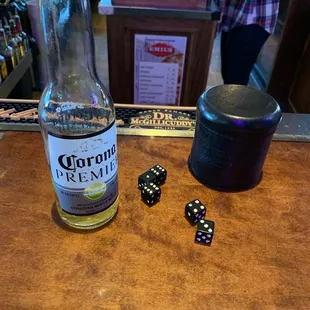 a bottle of liquor and dice